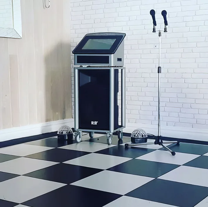 A black and white checkered floor with a karaoke machine.