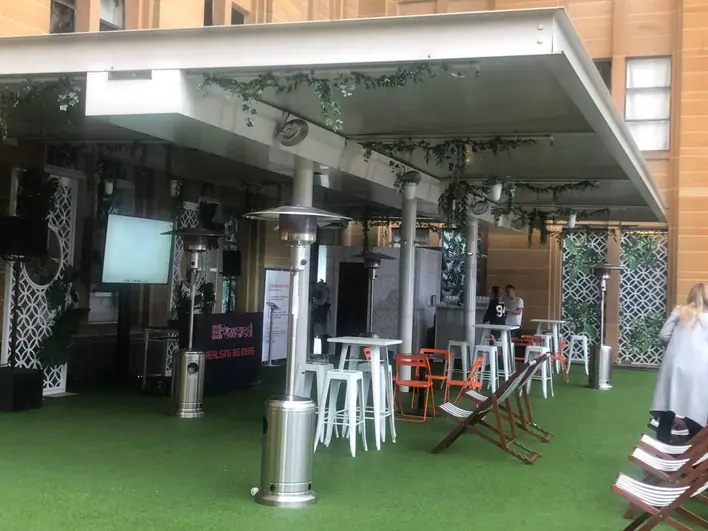 A large outdoor area with tables and chairs.