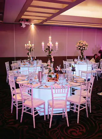 White Tiffany Chairs for events with Glowing Tables