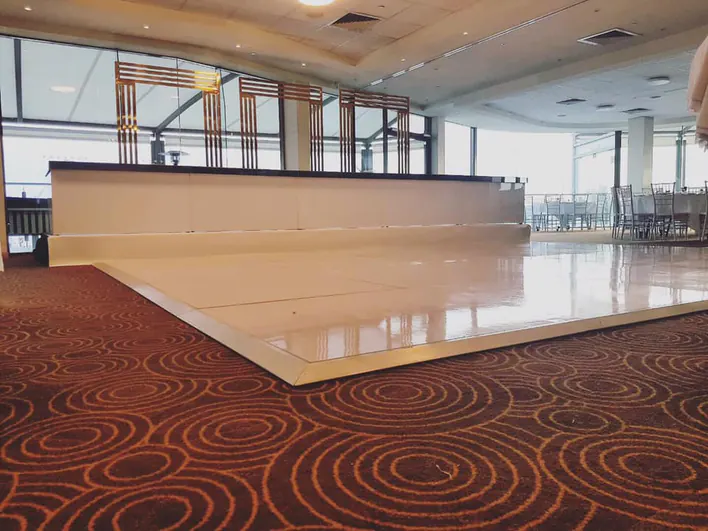 A white dance floor in a large room.