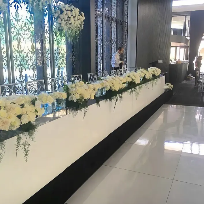 White flowers on a table in a hotel lobby.