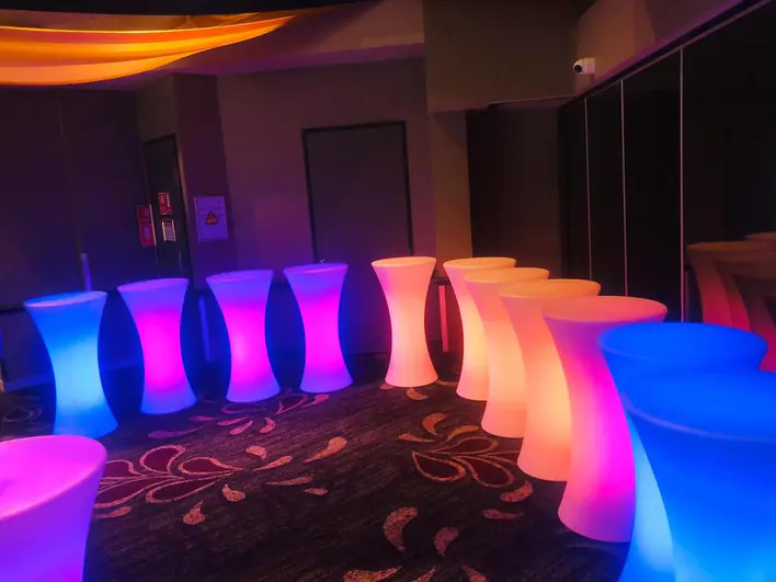 A group of colorful led stools in a room.