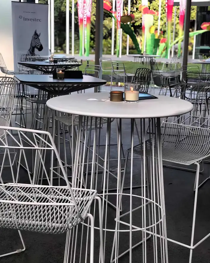 A white table and chairs in an outdoor setting.