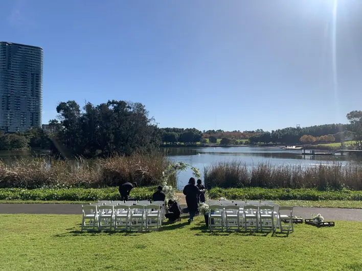 A wedding ceremony set up in front of a lake.
