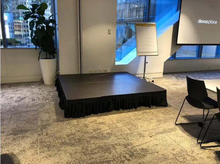 A conference room with a black table and chairs.