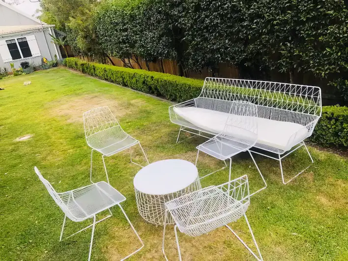 A white patio set with a table and chairs.