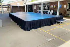 An outdoor stage in a school courtyard