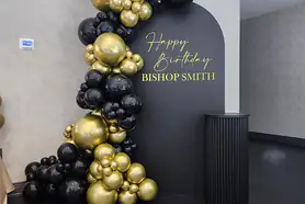 Stylish balloon garland for a birthday with golden black balloons