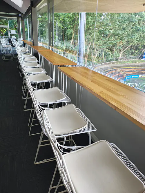 White wire stools set up at a sports ground