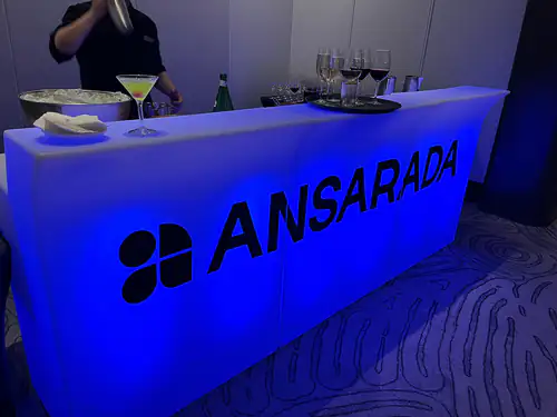 A blue glow bar with a corporate logo on it