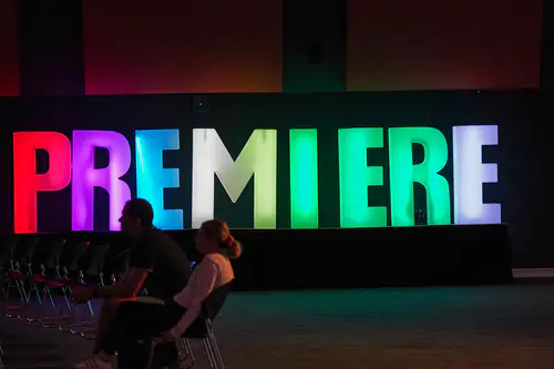 Large glow letters in multiple colours that spell 'PREMIER'