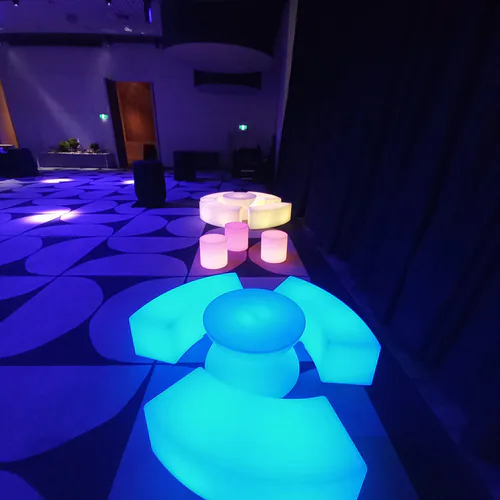 Two sets of glowing tables and stools