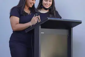 Ladies testing a lectern on stage
