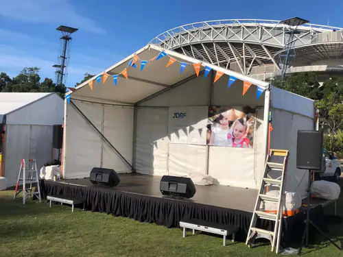 Professional stage platform with black skirting set up for a corporate or event presentation
