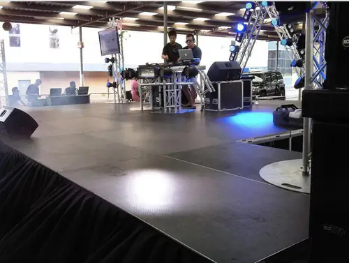 Event stage platform with black skirting positioned in a spacious indoor function room