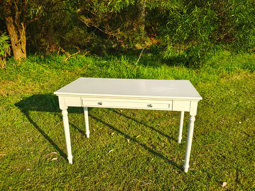 Our white wooden signing table on the grass at a park