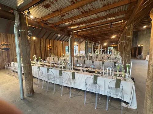 Tables and chairs beautifully set up for an indoor wedding reception