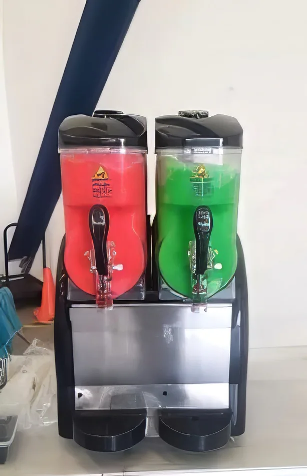 Two soda dispensers sitting on top of a table, offering a variety of drinks with Slushie Machine Hire: Pkg 4 - serving up to 180 Drinks.
