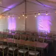A tent set up with tables and Timber Trestle Table 1.8m Hire.