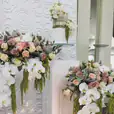 A small cake stand adorned with white orchids.