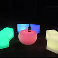 A set of colorful LED stools and a bottle of wine perfect for Glow Bench Hire events.