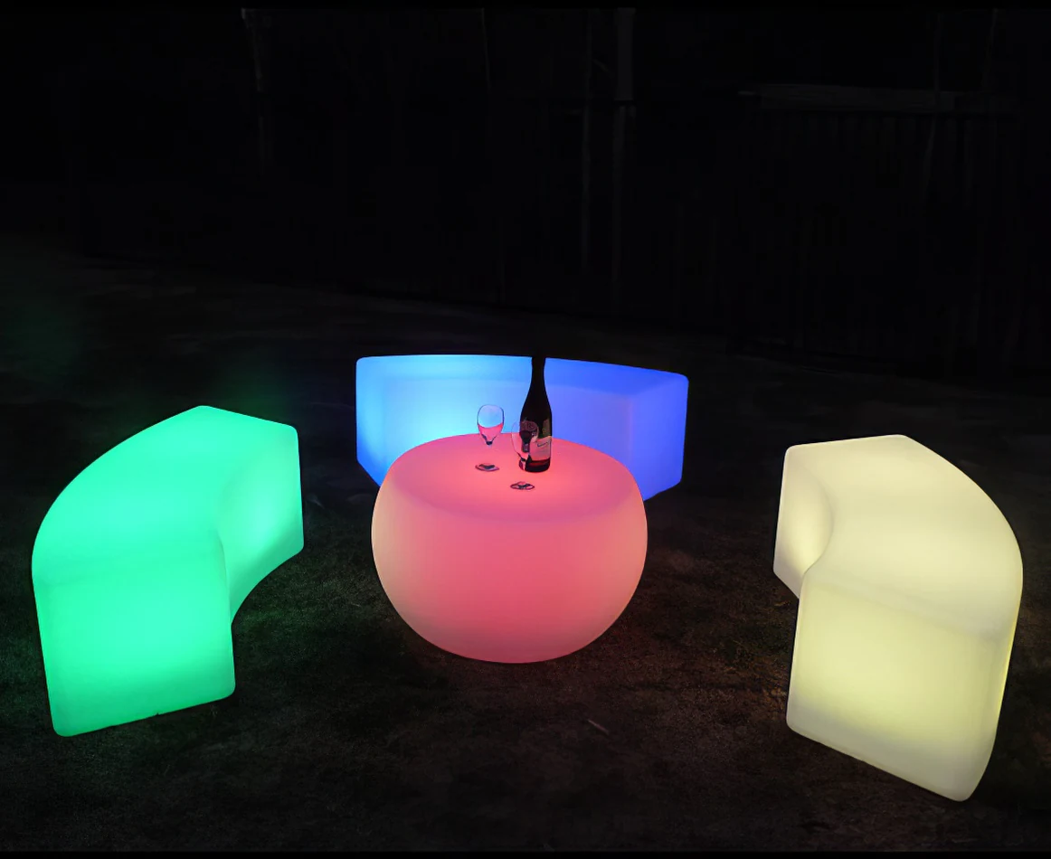 A set of colorful LED stools and a bottle of wine perfect for Glow Bench Hire events.