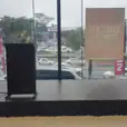 A stage with speakers and a lectern in front of a window.