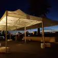 The stunning Sydney harbour bridge and sydney opera house illuminate the night sky, creating a mesmerizing spectacle under the 3mx6m Pop Up Marquee With White Roof.