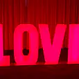 A large red "love" sign with glowing letters.