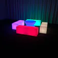 A room with a colorful table and chairs that glow.