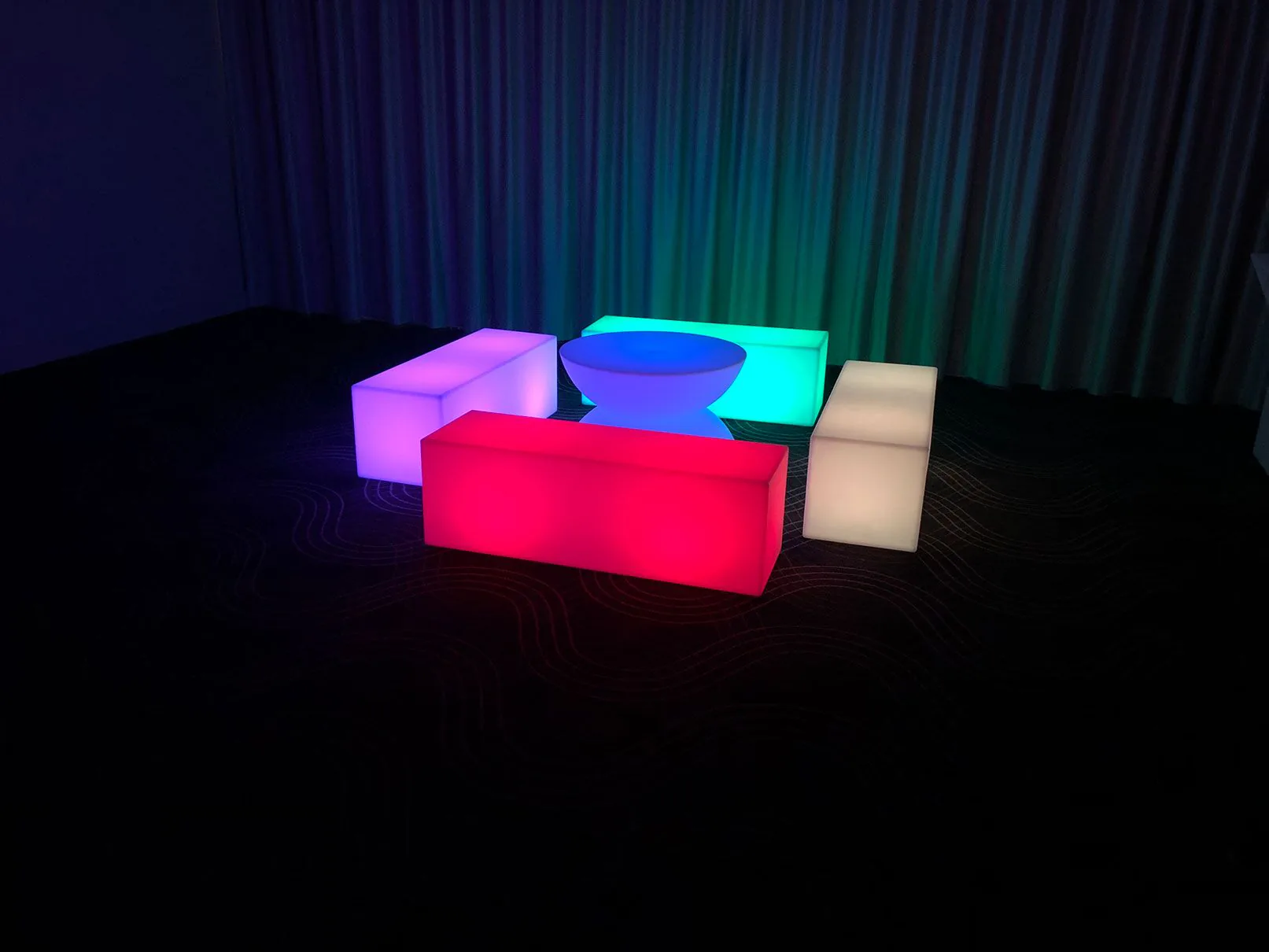 A room with a colorful table and chairs that glow.