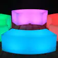 A set of vibrant lighted benches on a wooden floor.