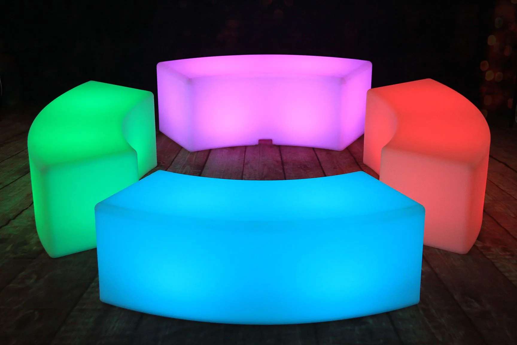 A set of vibrant lighted benches on a wooden floor.