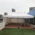 A 4mx8m Pop Up Marquee with walls on 3 sides, set up on the roof of a building.