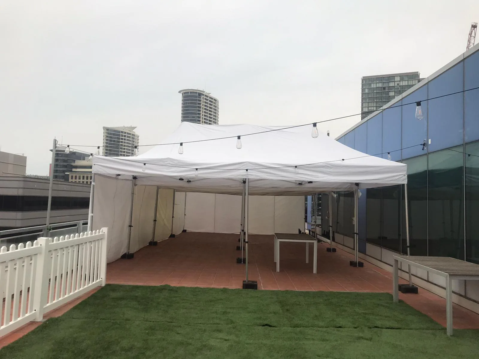A 4mx8m Pop Up Marquee with walls on 3 sides, set up on the roof of a building.