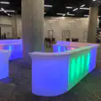 A vibrant glow bar centerpiece in the middle of a room.