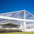 A 6m x 36m framed marquee set up on a grassy field.