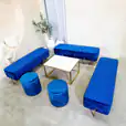 A lounge setting with navy blue ottoman benches