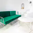 White Cross Coffee Table nest to an Emerald velvet lounge