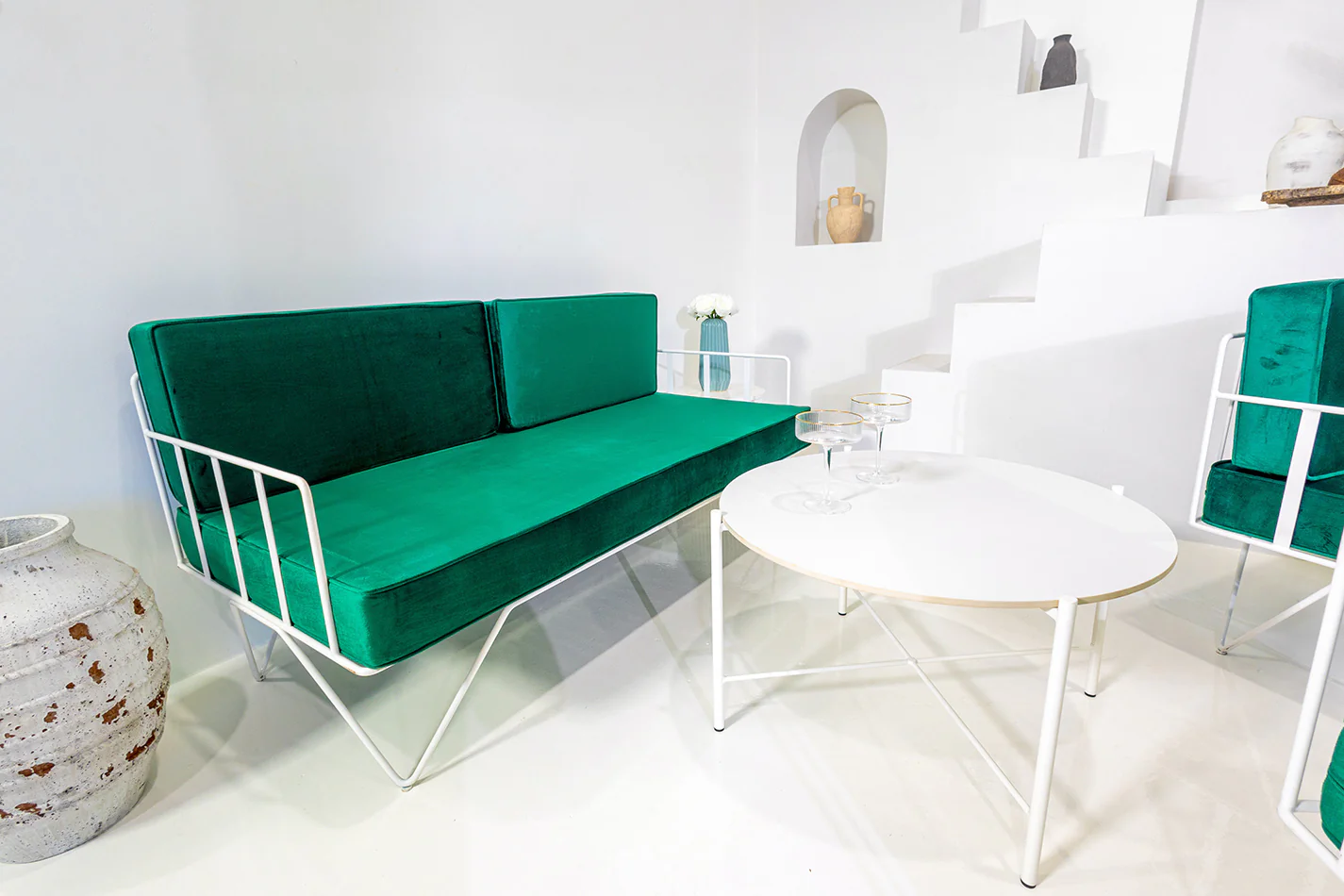 White Cross Coffee Table nest to an Emerald velvet lounge