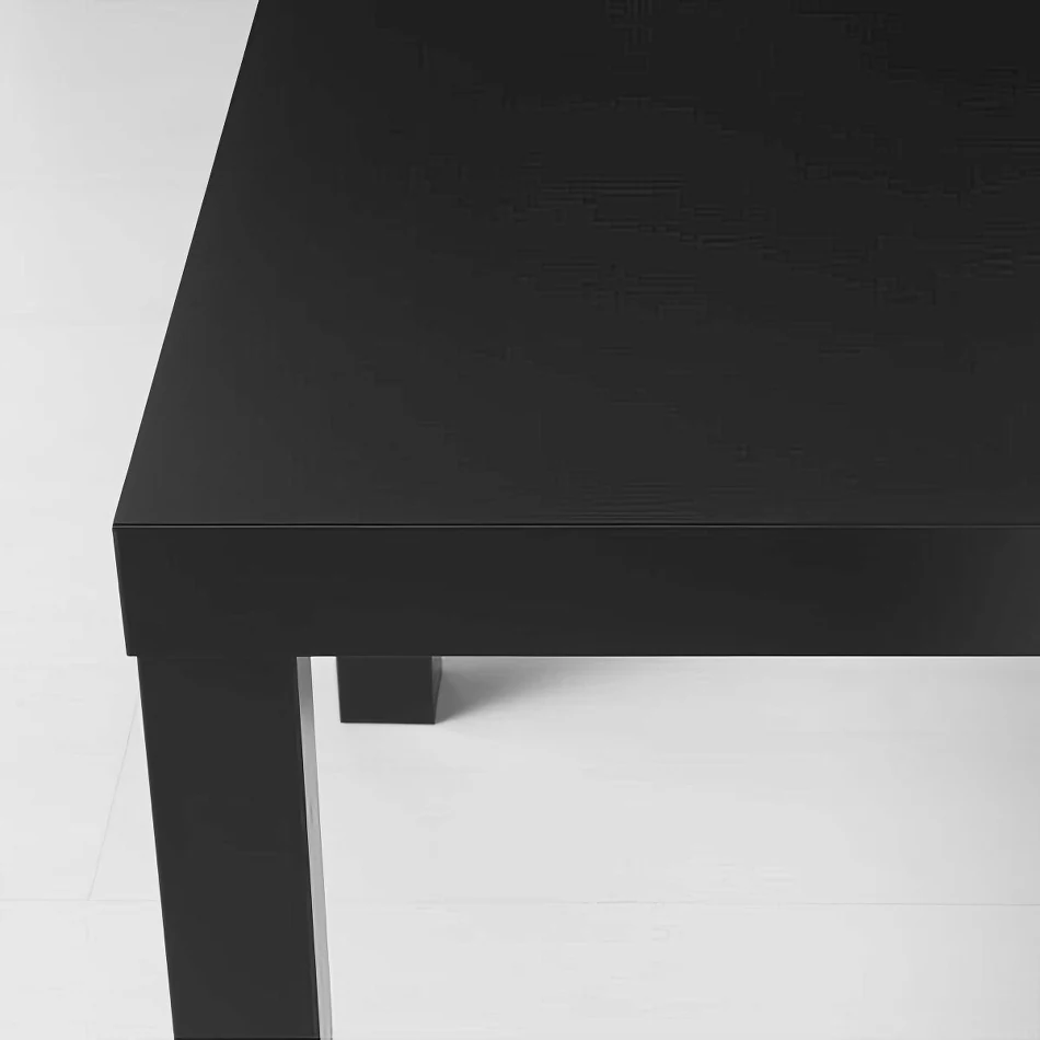 A black rectangular table on a white floor.