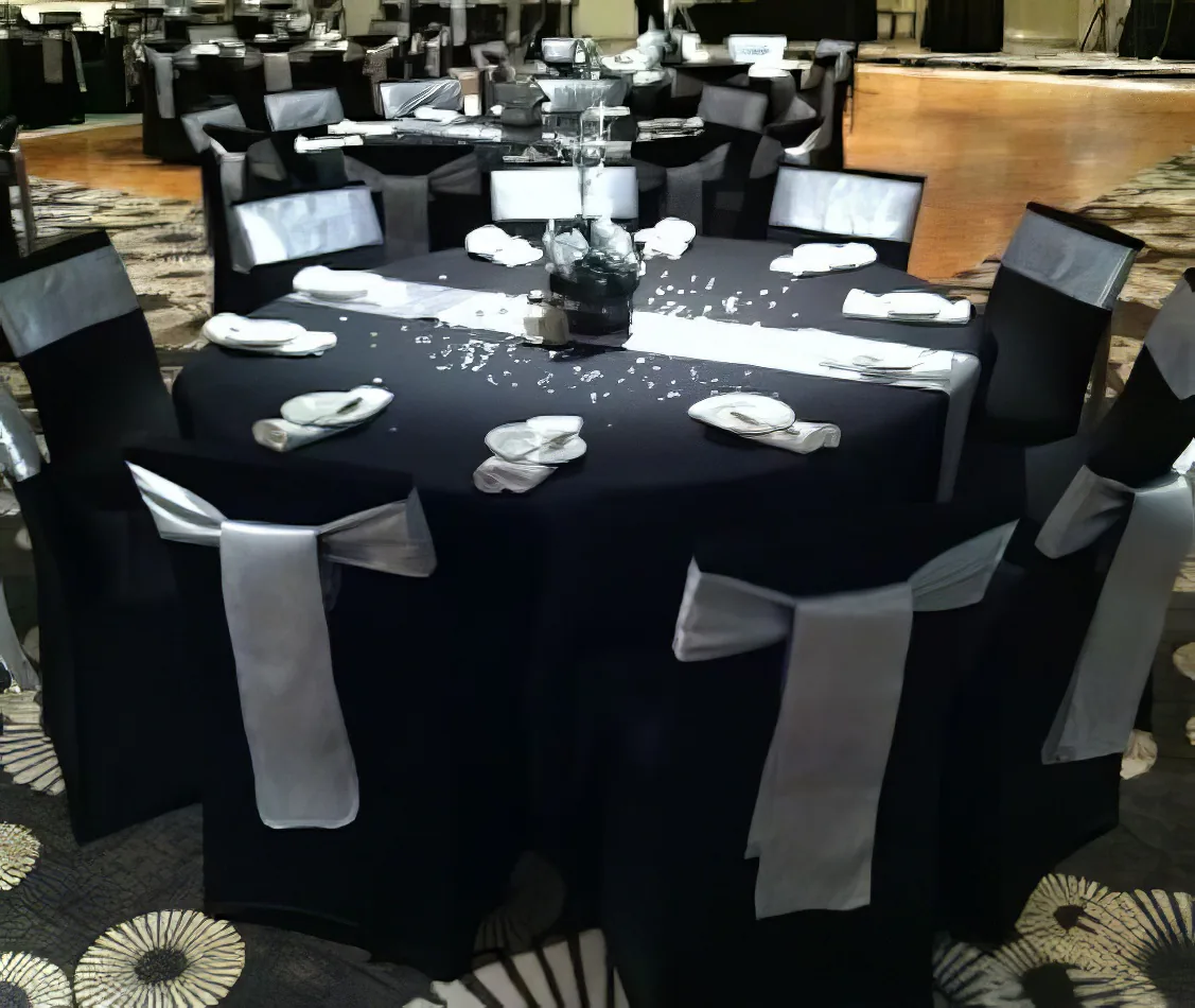 A black and silver banquet table adorned with elegant silver bows.