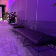 A black wire three seater lounge