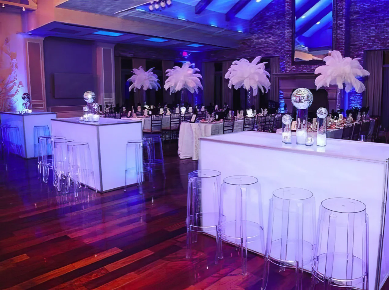 A party room with clear table and our ghost stools.