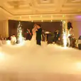 A bride and groom dancing with sparklers in the air, enhanced by the presence of a skilled operator offering dry sparkler hire.