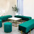 Emerald green velvet ottoman benches around a coffee table