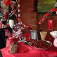 A table with a chocolate fountain overflowing with deliciously melted chocolate, accompanied by trays of ripe strawberries weighing 1kg.