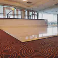 A glossy white dance floor in a large room, perfect for bridal events or table hire purposes.