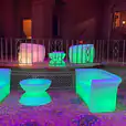 A double seater green couch and a purple chair in a living room.