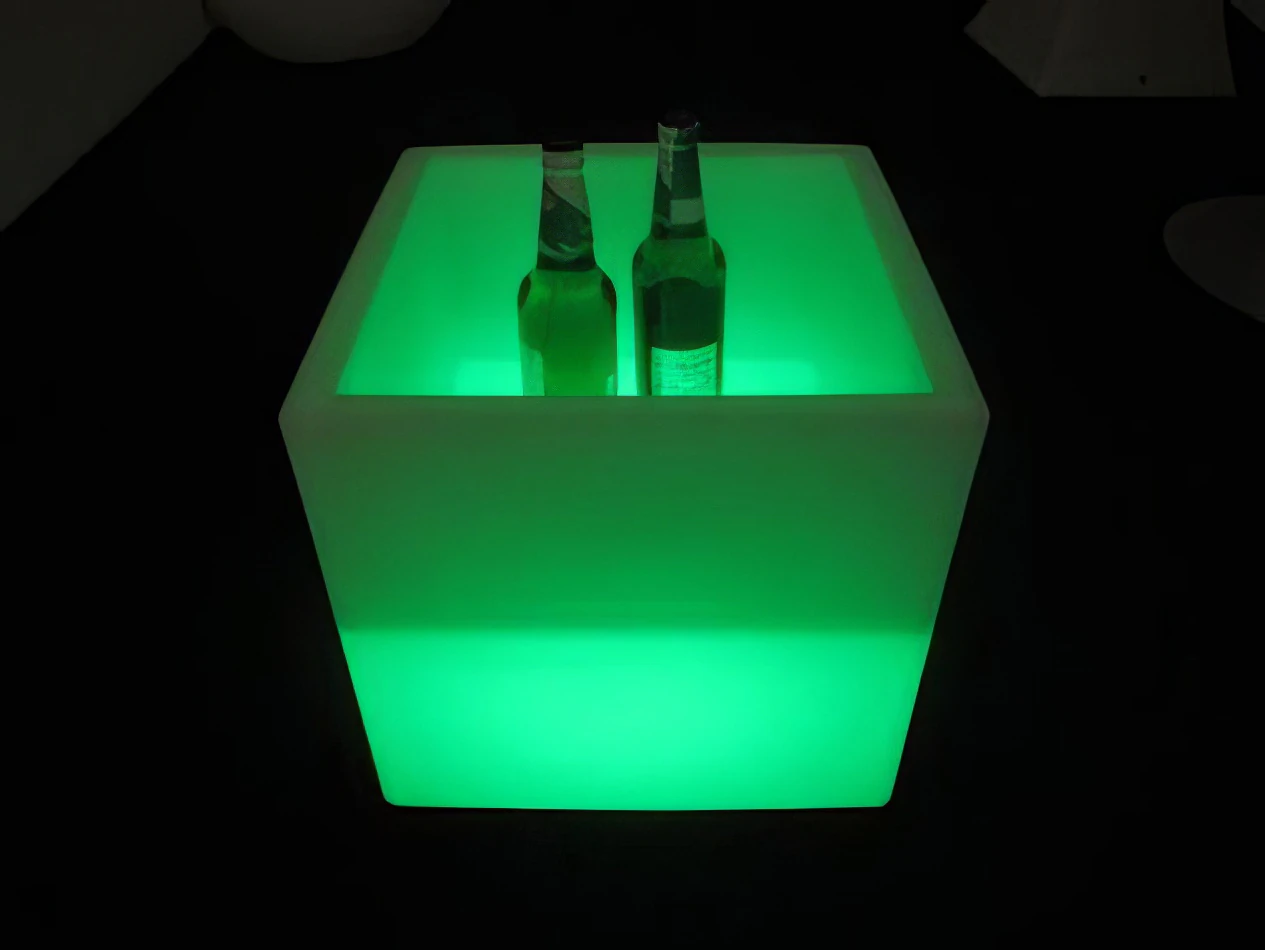 A glowing cube with two bottles inside for hire.